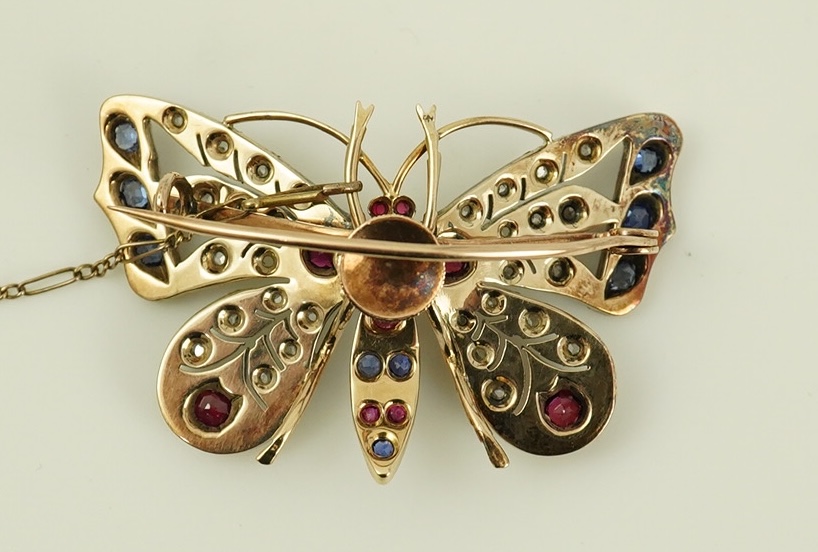 An Edwardian gold, ruby, sapphire and rose cut diamond set butterfly brooch